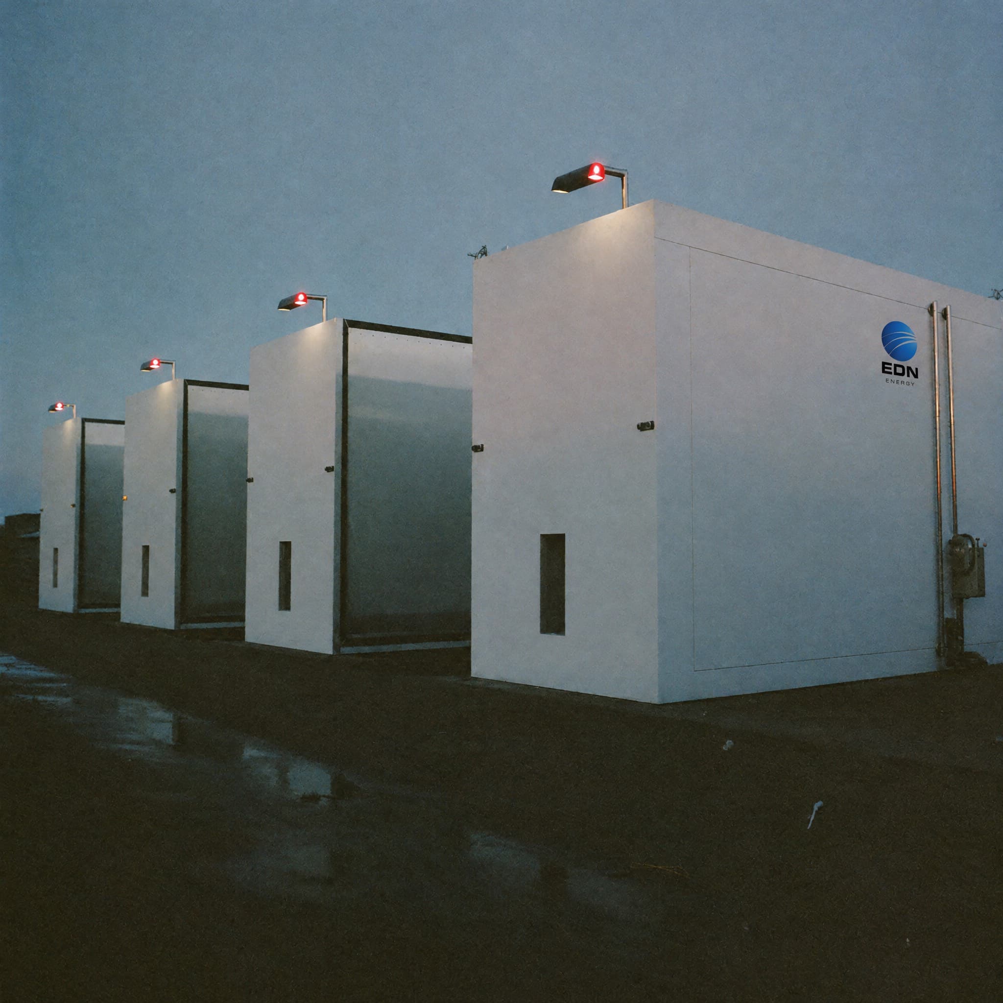 Battery storage containers at an industrial site at dusk