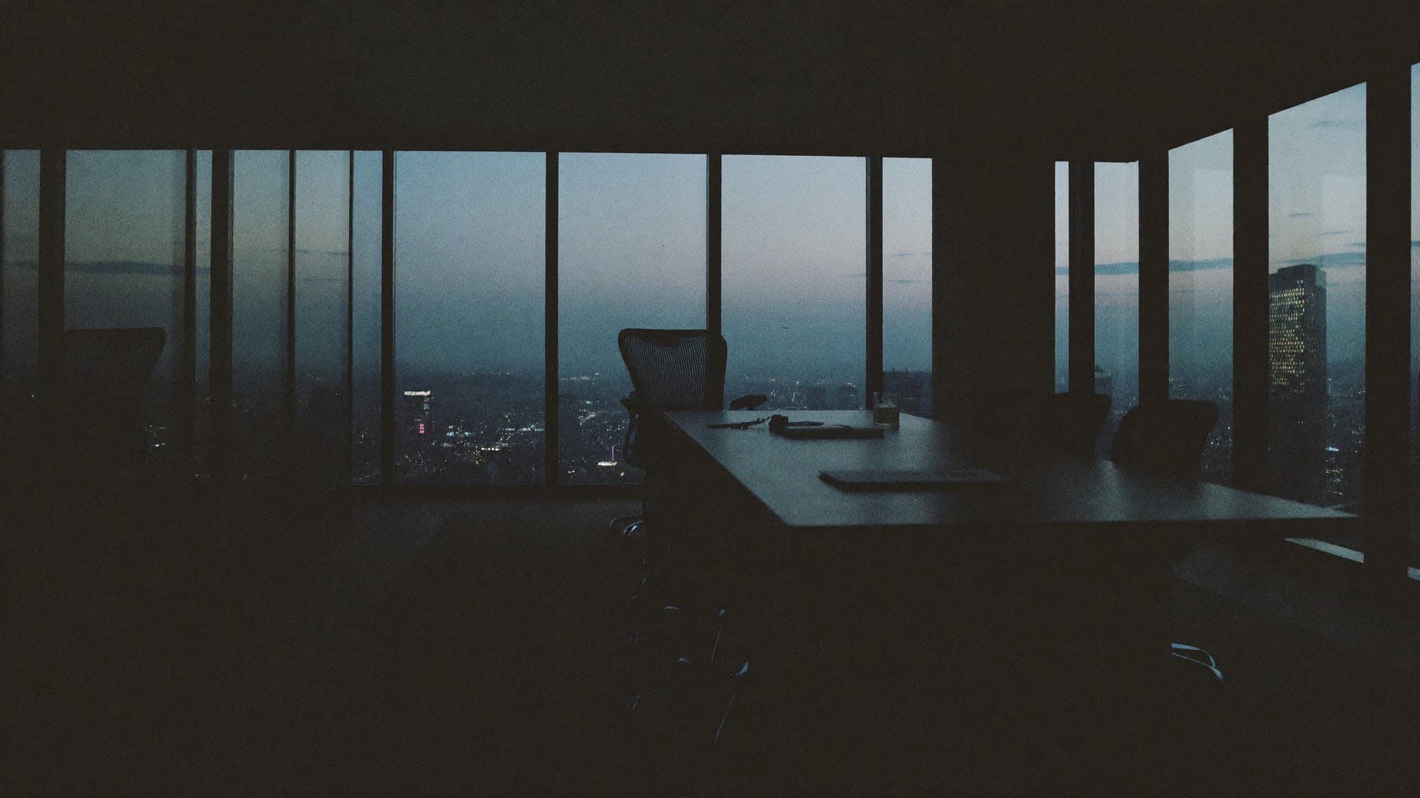 Empty boardroom overlooking the Abuja skyline at dusk