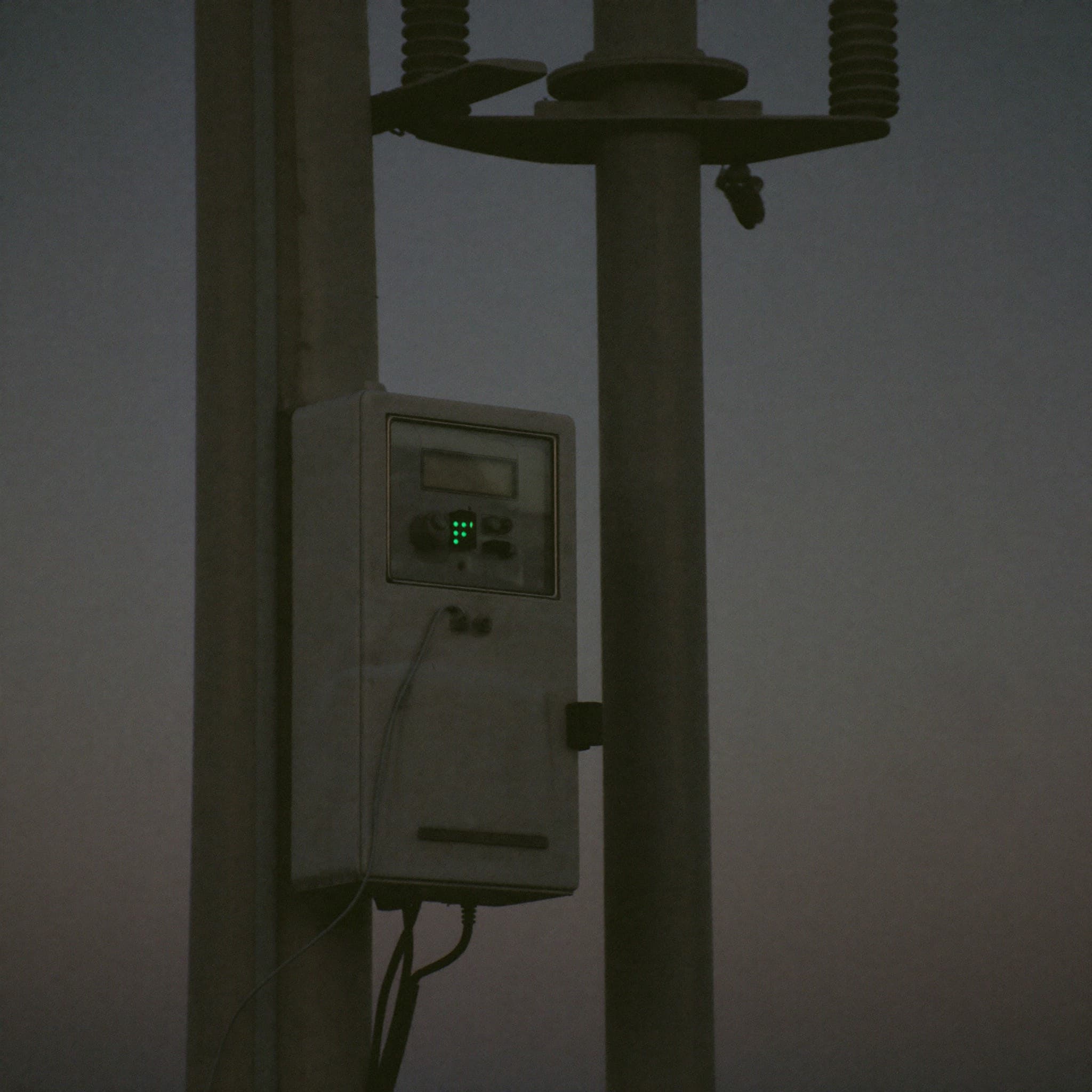 Grid controller box mounted beside a distribution transformer