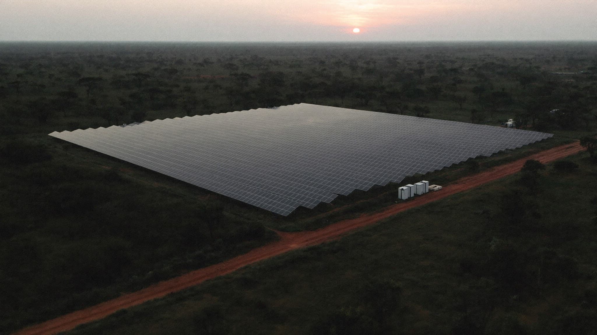Aerial view of a solar farm in the Nigerian savanna at dusk